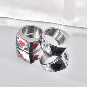 Close-up of Ace of Hearts and Spades poker rings made of polished stainless steel