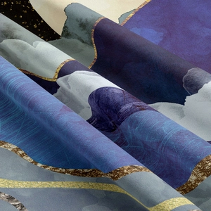 Close-up of abstract mountain tapestry fabric with golden lines and deep blue fluid patterns