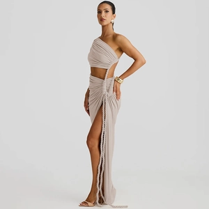 Detail of apricot one-shoulder dress with side cutout, rope ties and high slit detail