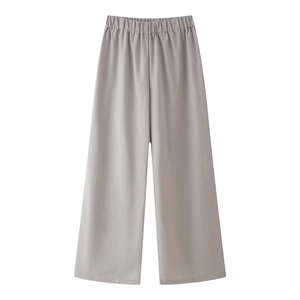 Detail of grey wide-leg linen trousers with elastic drawstring waist on white background