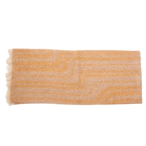 Close-up of wavy geometric jacquard pattern on soft beige and tan fringed scarf