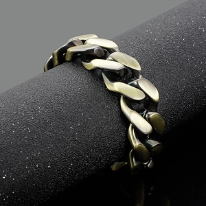 Macro view of vintage bronze curb chain bracelet showing brushed finish on black stand