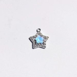 Detail of silver star pendant with blue flower center and sparkling rhinestones