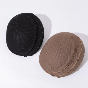 Close-up of elegant wool felt pillbox hats with mesh veil and beaded wave lace trim