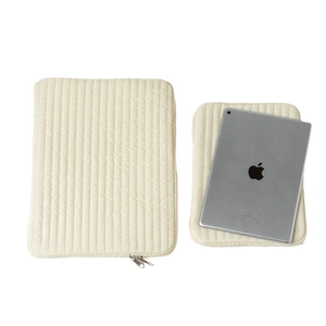 Quilted cream laptop sleeve and tablet case set with vertical stitching and metal zipper
