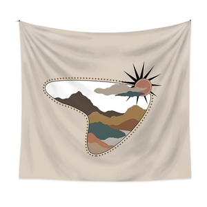 Detail view of bohemian wall tapestry with abstract earth-toned mountains and sun