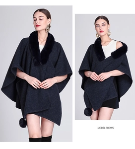 Detail of grey knitted poncho shawl with soft black faux fur collar on a fashion model