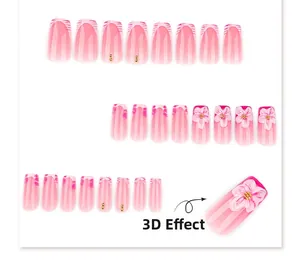 Detail of pink zebra pattern press-on nails with 3D embossed flowers and gold beads