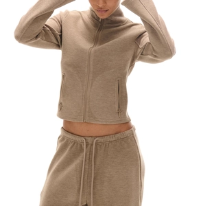 Detail of brown waffle knit tracksuit showing zip-up jacket and drawstring joggers texture