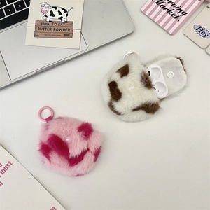 Close-up of plush heart earphone case featuring soft camo and cow print textures