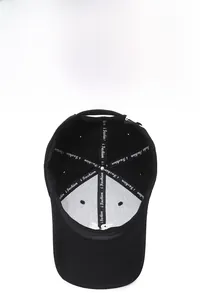 Detail of breathable black baseball cap interior with reinforced i Fashion branding tape