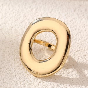 Close-up of a gold irregular hollow O-shape ring with handmade hammered texture detail