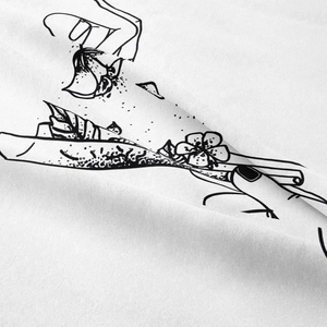 Detailed close-up showing black line art illustration on white fabric background