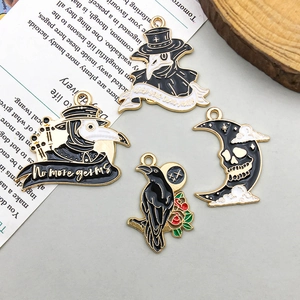 Macro shot of Gothic plague doctor enamel charms and raven pendants for DIY jewelry