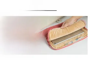 Detail view of pink quilted laptop sleeve with thick plush lining and smooth metal zipper