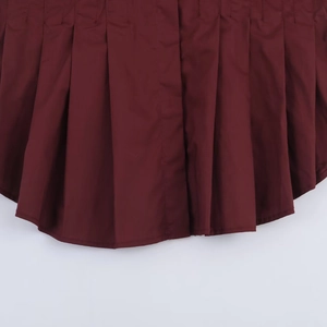 Detail of burgundy pleated poplin hem with high-quality stitching and matte texture