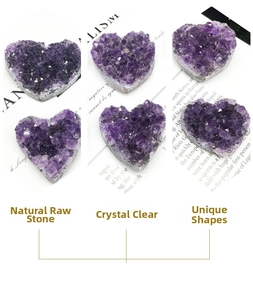 Multiple heart-shaped natural amethyst crystal clusters displayed on vintage paper