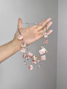 Detail of multi-layer pink shell fragment necklace with silver beads and lobster clasp