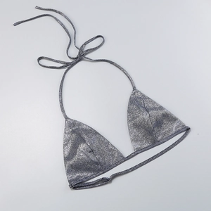Close-up of a silver sequined bikini top with thin halter straps and metallic finish