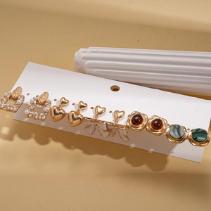 Detail of 10-piece earring set featuring resin pearls and rhinestones on card display