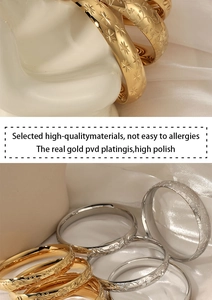 Detailed view of vintage gold and silver bracelets with intricate floral carvings