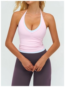 Detail of pink and blue layered halter yoga top with V-neck and purple high waist leggings