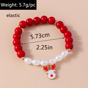 Close-up of Christmas beaded bracelet with red beads and cute reindeer enamel charm