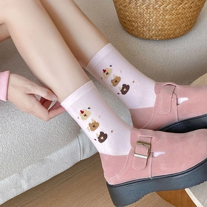 Pink mid-calf cotton socks with cute bear pattern worn with pink platform shoes