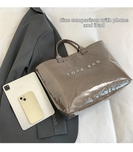 Detail of dark brown tote bag showing large capacity for iPad and smartphone