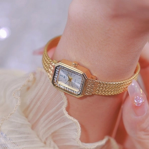 Elegant gold square watch for women with diamond bezel and metal mesh band on wrist