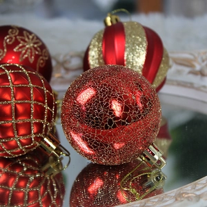 Set of 44 red and gold Christmas ornaments with glitter patterns and reflective finish