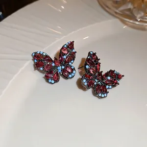 Vintage zircon butterfly earrings in black nickel with red and blue crystals