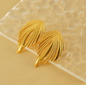 Macro shot of 18K gold plated woven texture earrings with wheat grain design details
