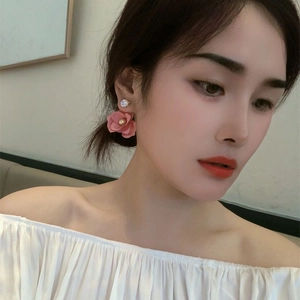 Elegant pink camellia flower earrings with clear zircon stud on model's ear