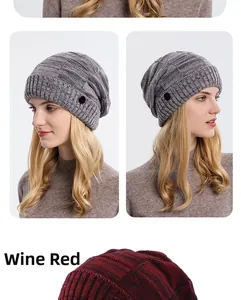 Detail view of wine red and grey knitted beanies with thick texture and side button