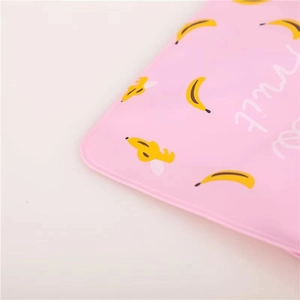 Detail of pink PVC hot water bag corner with cute yellow banana print and fruit text
