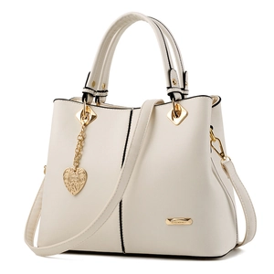 Elegant cream tote bag with gold hardware, detachable strap, and heart charm for women