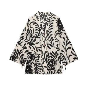 Women's kimono cardigan and trousers set with black leaf print on a white background