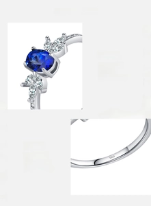 Close-up of S925 silver ring featuring an oval blue gem and white zircon inlay