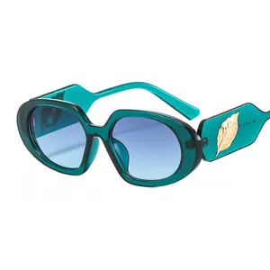 Retro oval sunglasses with dark green acetate frames and golden leaf metal accents