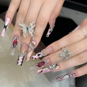Retro punk style chrome heart nail art set with asymmetric stars and butterfly charms
