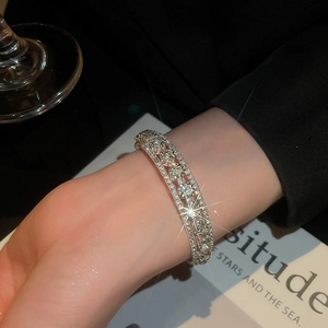 Macro detail of silver triple-layer bracelet featuring sparkling zircon pavé setting