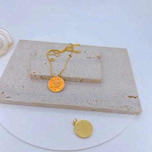 Macro detail of gold plated evil eye pendant necklace on natural travertine stone