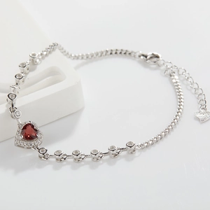Macro detail of S925 hallmark on heart garnet bracelet with white zircon accents