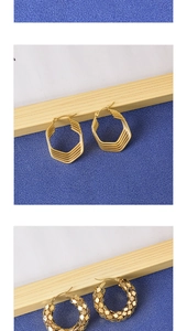 Macro detail of hexagonal geometric gold hoops and textured scale pattern earrings