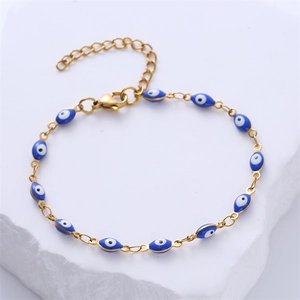 Detail of gold evil eye bracelet showing oval blue charms and lobster clasp closure