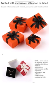 Detail view of multi-size jewelry boxes with bow ribbons and black flocking inserts