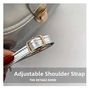 Detail showing adjustable silver leather shoulder strap with golden metal pin buckle