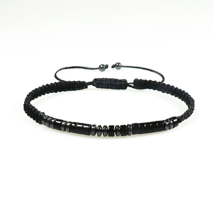 Adjustable Morse code bracelet with black obsidian and tiger eye beads on white background