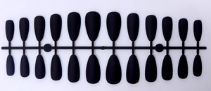 Macro view of matte black long almond press-on nails with fine frosted texture surface